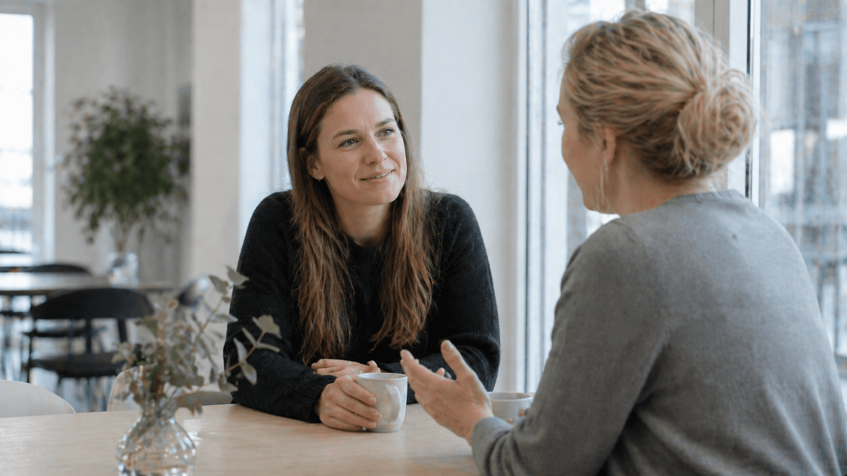 Two colleagues in an informal conversation at the office